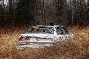 abandoned car in field